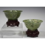 A pair of Chinese jade bowls, 20th century, of flared circular form, the stone of semi-translucent