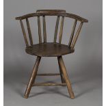 A 19th century beech and stained softwood primitive stick back chair with rounded solid seat, on