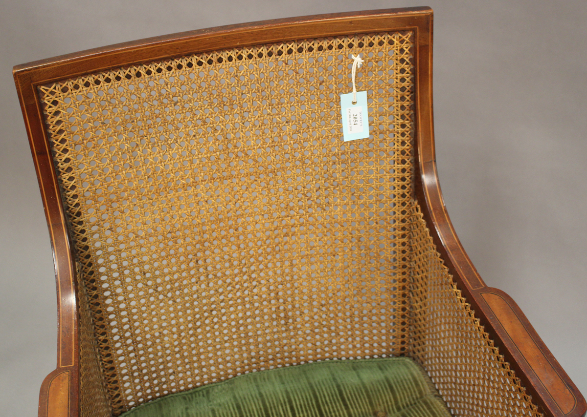 An Edwardian mahogany bergère library armchair, the caned seat, back and side panels within a - Image 2 of 3
