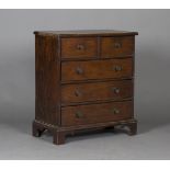 A small 18th century provincial oak chest of two short and three long drawers, on bracket feet,