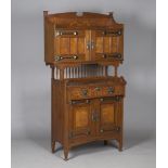 An Edwardian Arts and Crafts oak and pollard oak side cabinet by Shapland & Petter of Barnstaple,