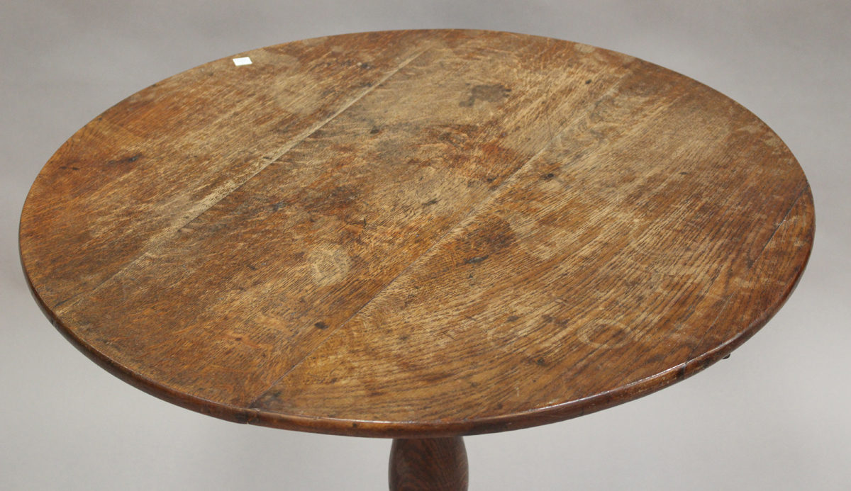 A late George III provincial oak circular tip-top wine table, raised on a turned baluster stem and - Image 4 of 4