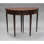 A late George III mahogany fold-over demi-lune tea table with crossbanded borders and boxwood