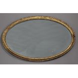 A George III giltwood oval wall mirror with a beaded frame, 66cm x 46cm.Buyer’s Premium 29.4% (