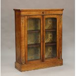 A late Victorian walnut two-door pier cabinet with boxwood line inlaid borders and gilt metal