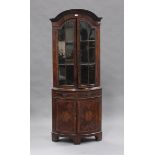 A late 19th/early 20th century George I style walnut floor-standing bowfront corner cabinet, the