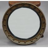 A 20th century Regency style gilt composition convex wall mirror with ball shot decorated frame,