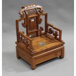 A 20th century Chinese softwood low seated chair with a carved and pierced back above a removable