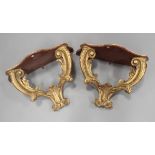 A pair of late 19th century giltwood wall brackets, the serpentine tops above foliate scroll