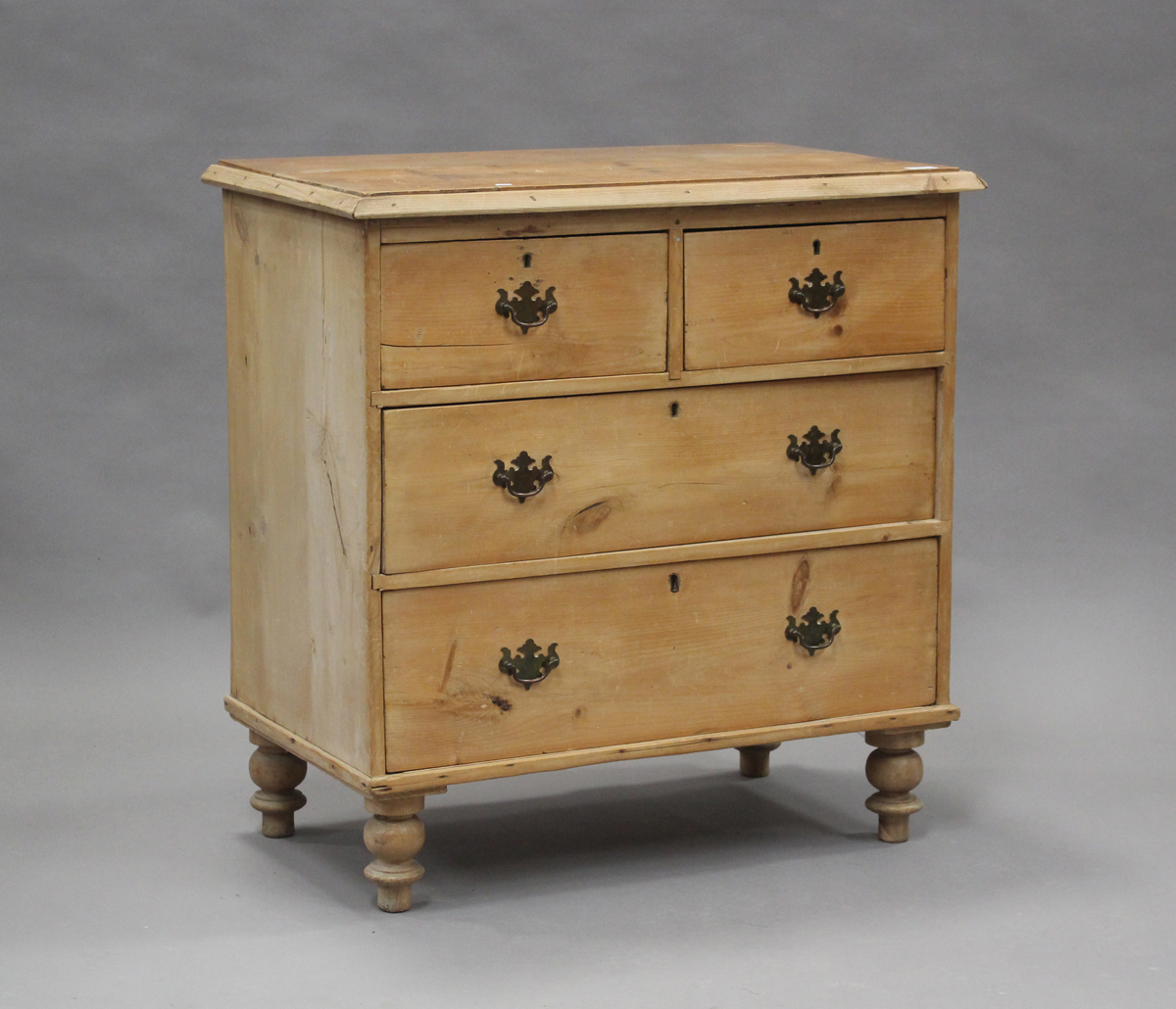 A late Victorian pine chest of two short and two long drawers, on turned legs, height 85cm, width