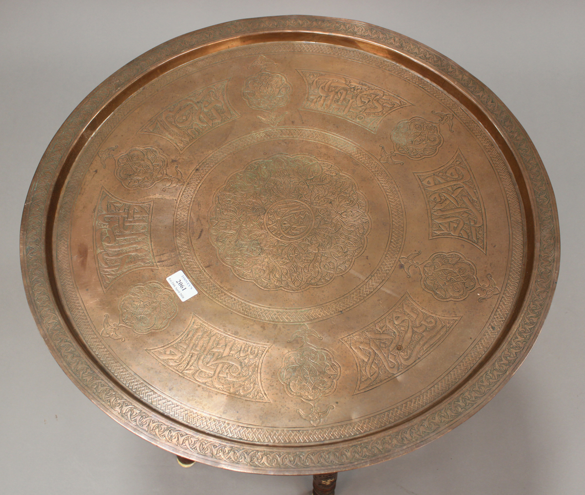 A late 19th/early 20th century Middle Eastern Islamic tray-top table, the circular copper tray - Image 2 of 3