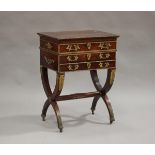 A 19th century figured mahogany and gilt metal mounted sewing table, the hinged lid enclosing a