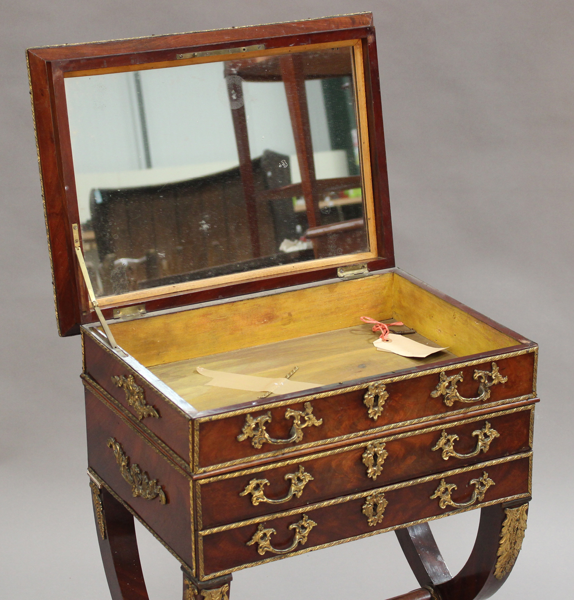 A 19th century figured mahogany and gilt metal mounted sewing table, the hinged lid enclosing a - Image 2 of 3