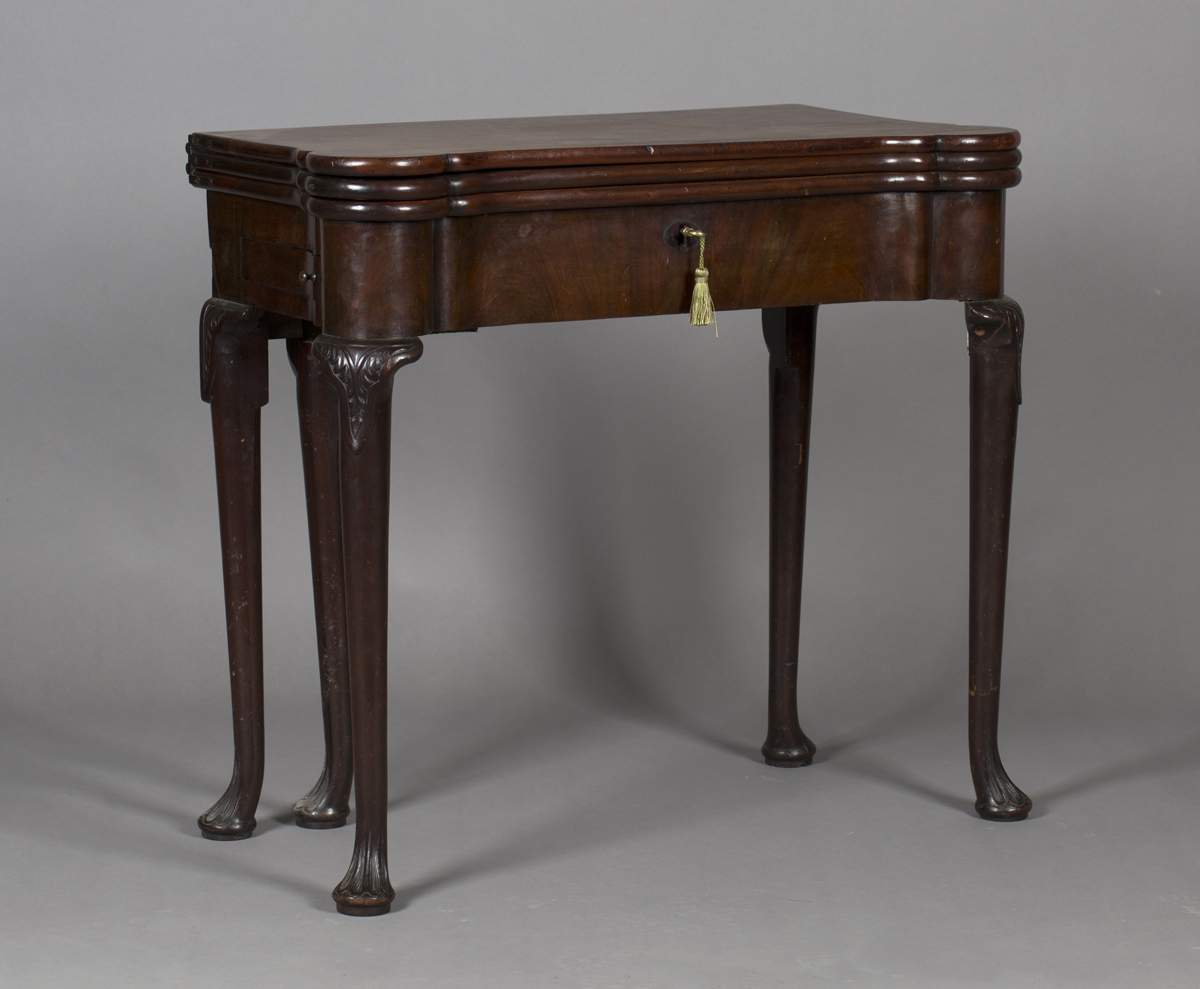 A George II mahogany triple leaf fold-over games and tea table, the hinged top with projecting