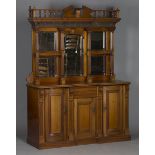 An Edwardian walnut side cabinet, the swan neck and turned balustrade pediment above a concave