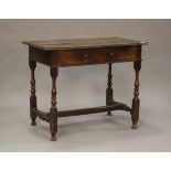 An early 18th century walnut side table, fitted with a single drawer, on turned and block legs,