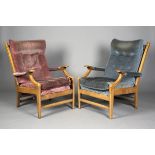 A pair of mid-20th century teak framed armchairs, possibly by Parker Knoll, with unusual shaped