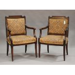 A pair of late 18th/early 19th century French walnut framed fauteuil armchairs, the top rails finely