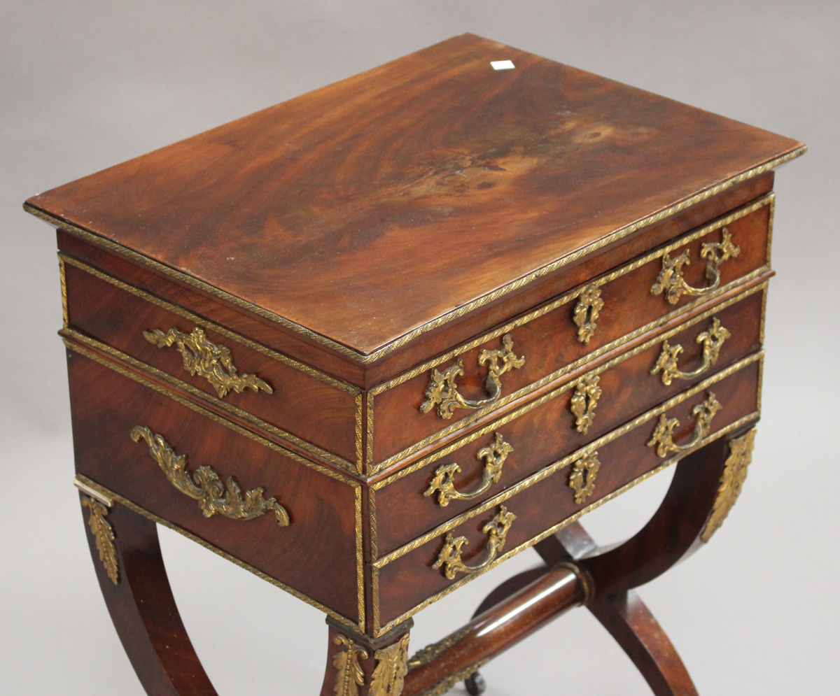 A 19th century figured mahogany and gilt metal mounted sewing table, the hinged lid enclosing a - Image 3 of 3