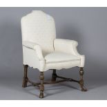 An early 20th century Carolean Revival walnut armchair, upholstered in patterned cream damask,