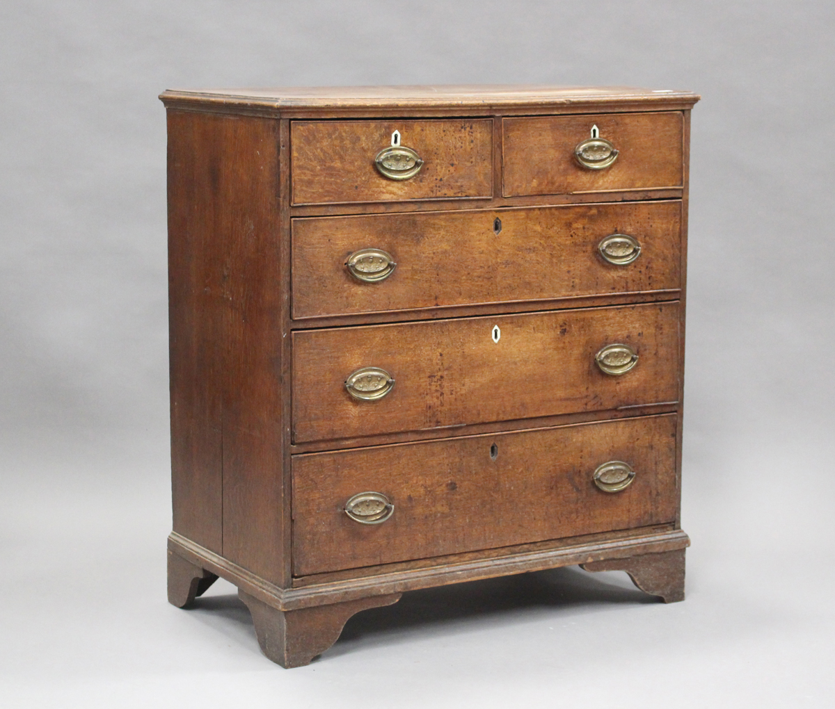 A George III oak chest of two short and three long drawers, on bracket feet, height 104cm, width