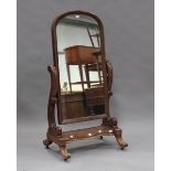 A mid-Victorian mahogany cheval mirror with arched frame and scroll supports, height 160cm, width