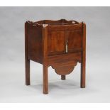 An early 19th century mahogany night cupboard, the galleried top above a pair of doors and a drawer,