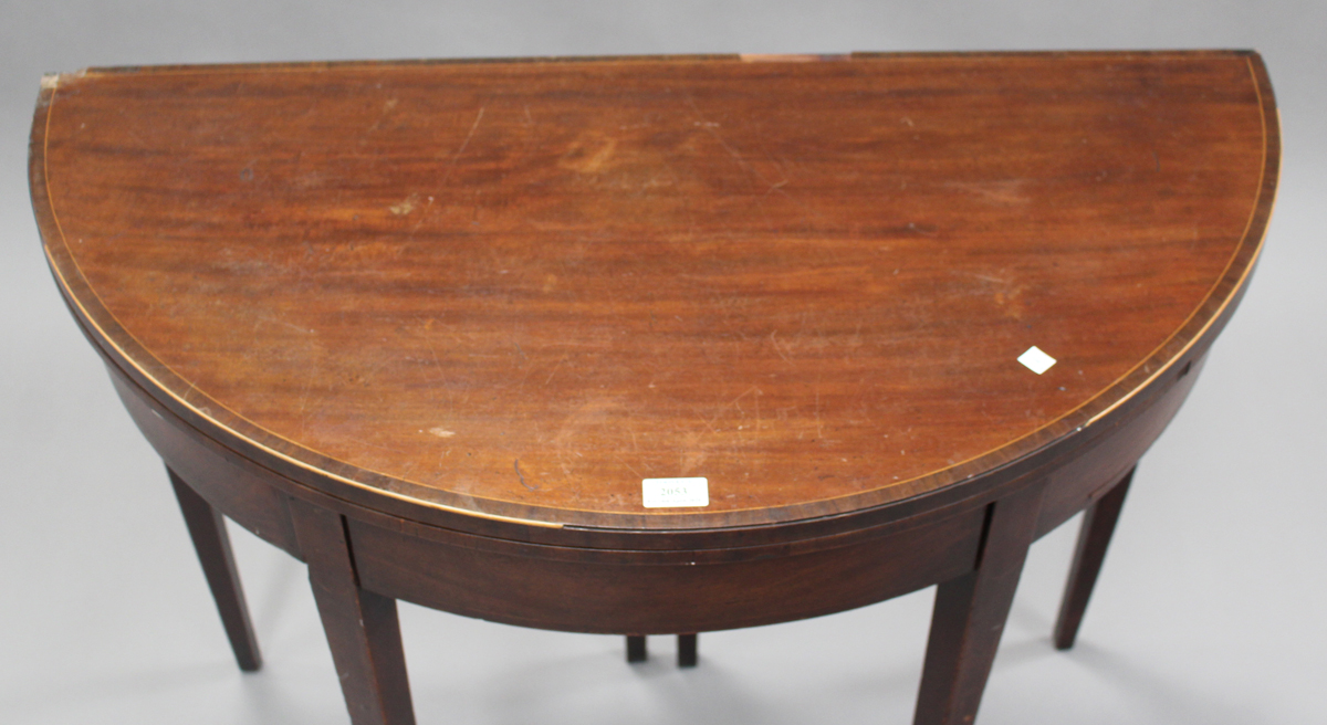 A late George III mahogany fold-over demi-lune tea table with crossbanded borders and boxwood - Image 2 of 2