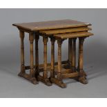 A late 20th century Carolean style oak nest of three occasional tables, on turned legs and bracket