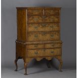 A George I walnut chest-on-stand, the moulded pediment above two short and three long oak-lined