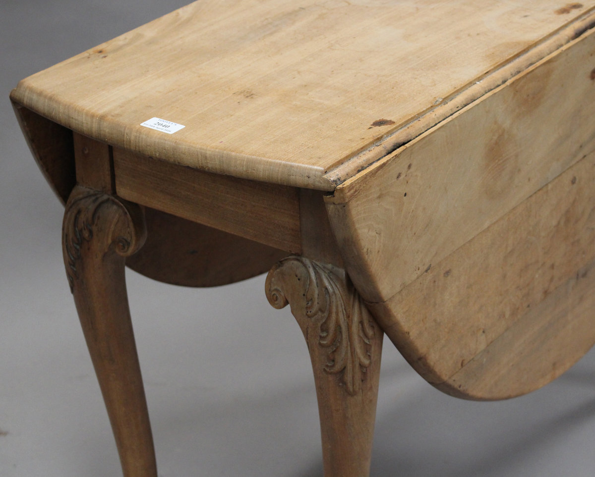 An 18th century faded pale mahogany oval drop-flap supper table, raised on carved acanthus - Image 3 of 3