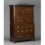 A 19th century George III style mahogany chest-on-chest, the cavetto and dentil moulded pediment