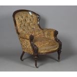 A late Victorian walnut showframe salon armchair, upholstered in the remnants of period buttoned