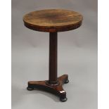 A Regency rosewood circular wine table, the octagonal stem on a triform base with bun feet, height