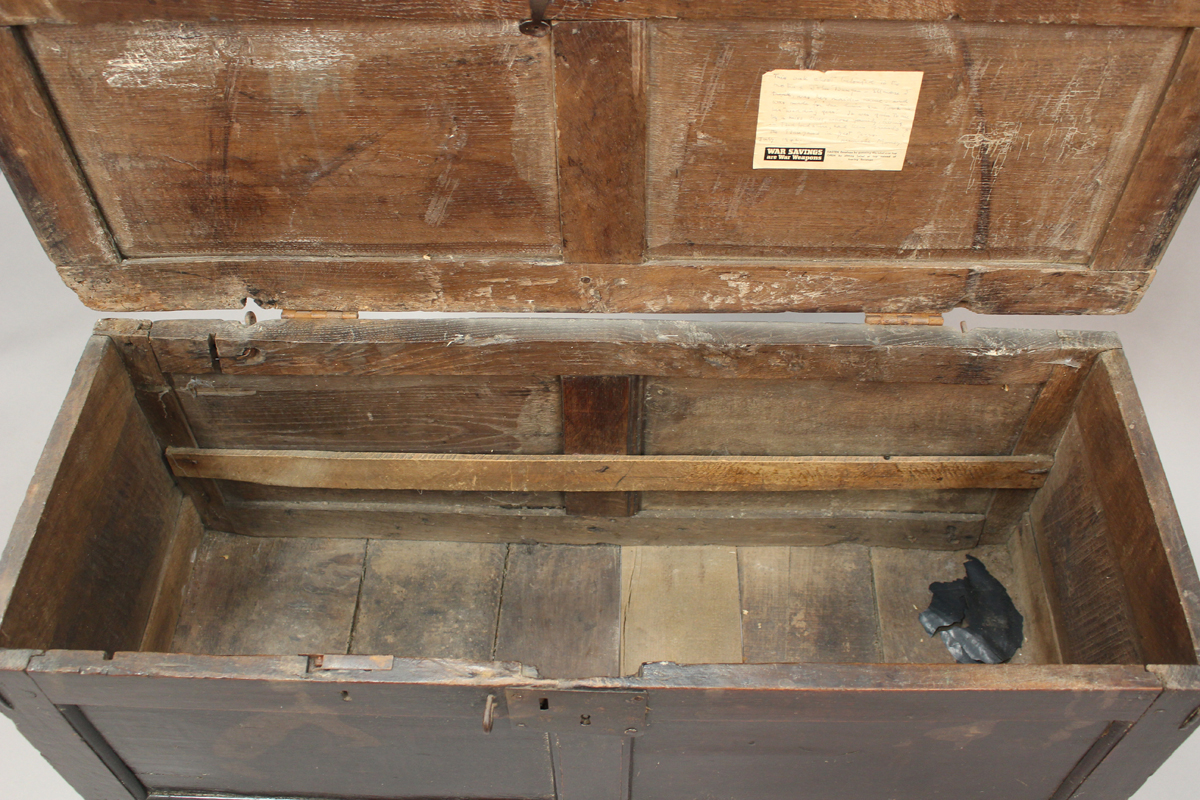 An early 18th century oak panelled coffer, the hinged lid with wrought iron latch, raised on long - Image 3 of 5