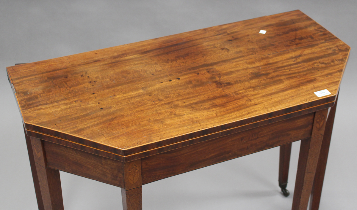 A George III mahogany fold-over tea table, the canted top with boxwood stringing, the frieze with - Image 2 of 3