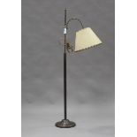 A modern anodized brass lamp standard with adjustable light fitting, height 150cm.Buyer’s Premium