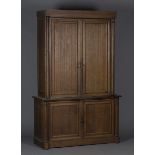 A mid-Victorian oak hall cupboard, fitted with four panelled doors flanked by architectural