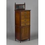 A late Victorian walnut music cabinet, the bevelled mirror gallery back above four drawers and a