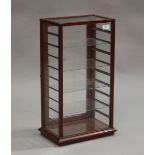 A late Victorian mahogany framed counter-top display cabinet, fitted with a hinged door and glass