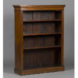 A late Victorian walnut open bookcase, fitted with three adjustable shelves flanked by fluted