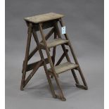 An early 20th century beech three-rung folding step ladder, height 66cm, width 39cm.Buyer’s