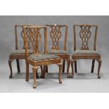 A set of four George III style provincial oak pierced splat back dining chairs with drop-in tapestry