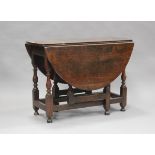 An early 18th century oak oval drop-flap supper table, fitted with a single drawer, on turned and