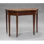 A George III mahogany fold-over tea table, the canted top with boxwood stringing, the frieze with