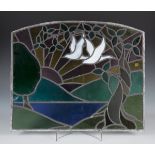 An Art Deco leaded and stained glass arched panel depicting two stylized birds and a tree with a