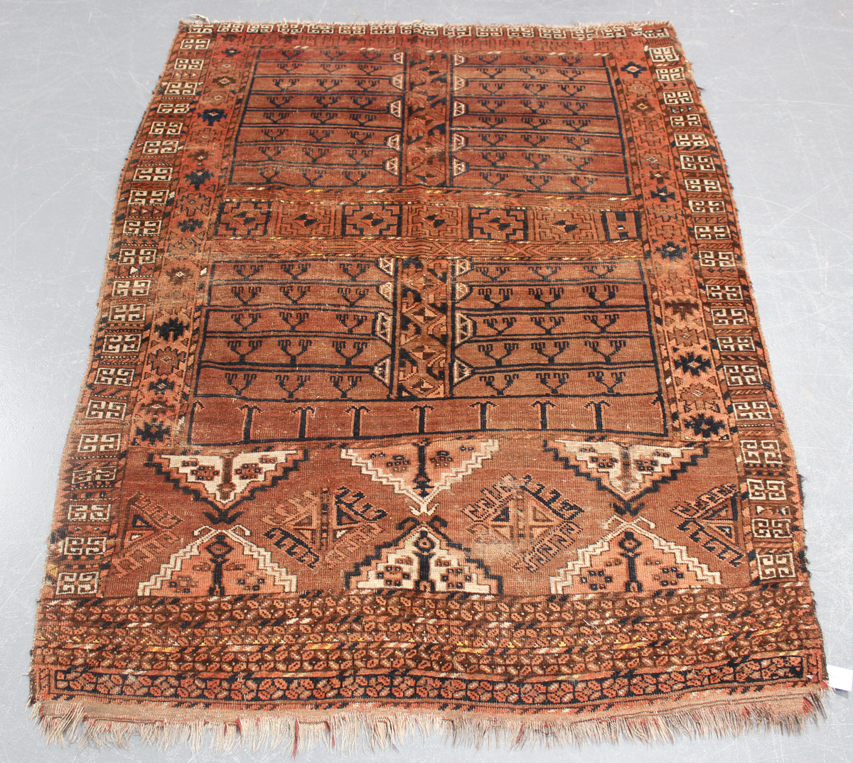 An Ersari ensi, South Turkestan, early 20th century, the faded claret field with four compartments