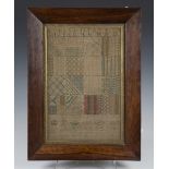 A late 17th/18th century needlework sampler, worked in coloured silks with lines of the alphabet and