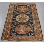 A Kazak rug, West Caucasus, early 20th century, the blue field with three octagonal medallions,