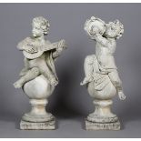 A pair of 20th century cast composition stone garden figures, each in the form of a putto seated
